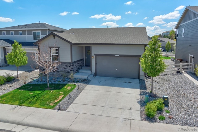 view of front facade with an attached garage, fence, and concrete driveway