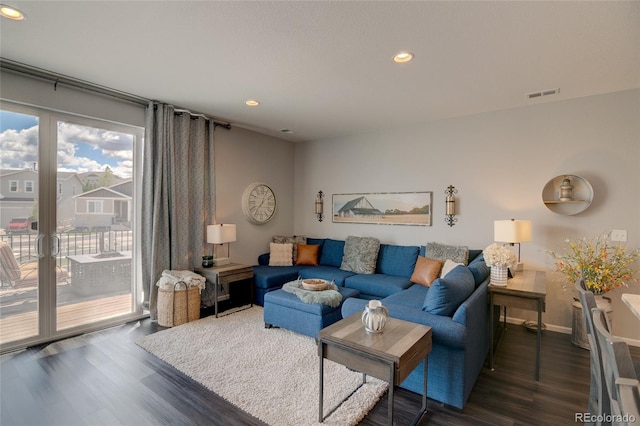 living area featuring dark wood-type flooring, recessed lighting, and baseboards