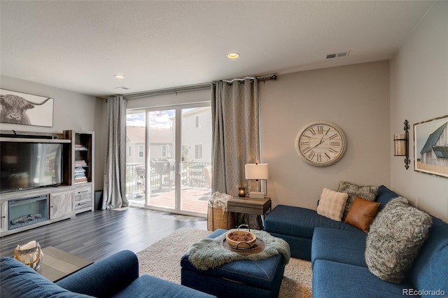 living room with wood finished floors and recessed lighting