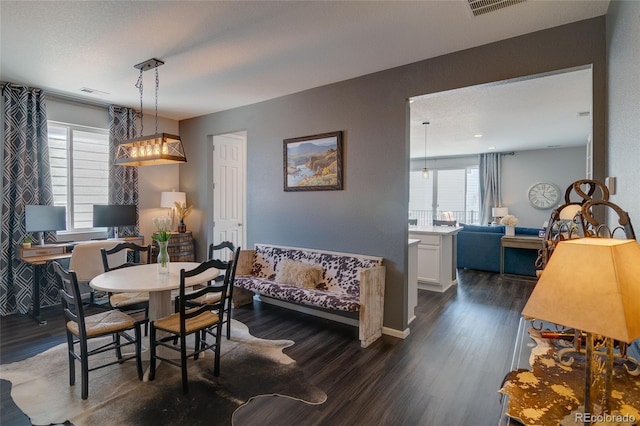 dining space featuring plenty of natural light and dark wood-style floors