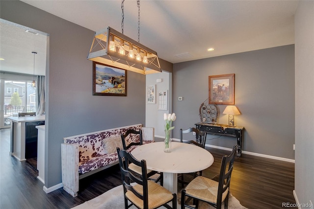 dining space featuring dark wood finished floors, baseboards, and recessed lighting