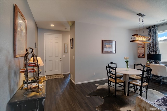 dining space featuring wood finished floors, baseboards, and recessed lighting