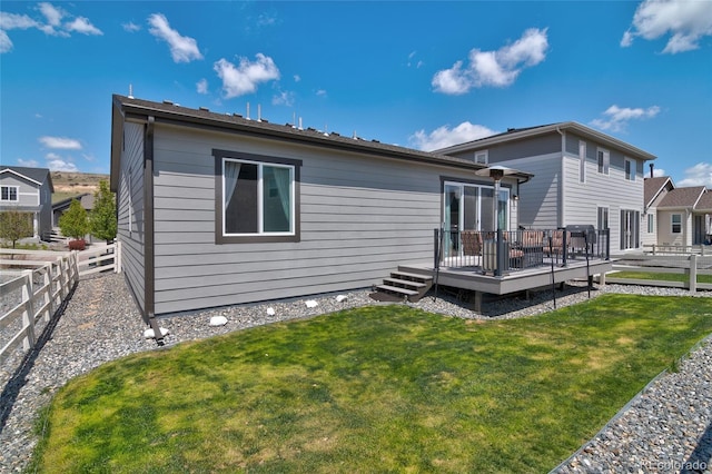 rear view of property featuring a wooden deck