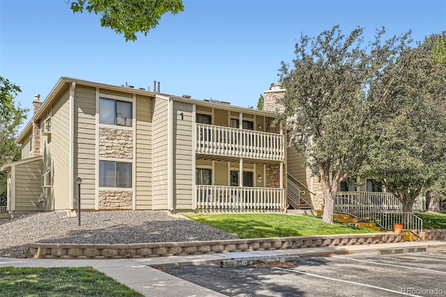 8225 Fairmount Dr Unit 104, Denver, CO 80247 - view of building exterior with uncovered parking