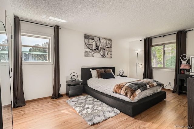 8225 Fairmount Dr Unit 104, Denver, CO 80247 - bedroom with a textured ceiling and light wood-type flooring