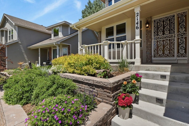 2146 S Ellis Ct, Lakewood, CO 80228 - doorway to property featuring a porch