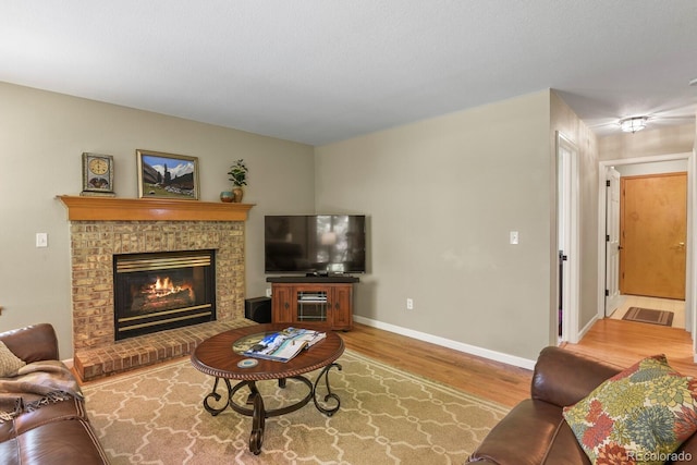 2146 S Ellis Ct, Lakewood, CO 80228 - living area with wood finished floors, baseboards, and a glass covered fireplace