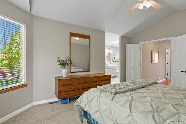 2146 S Ellis Ct, Lakewood, CO 80228 - carpeted bedroom featuring multiple windows, baseboards, connected bathroom, lofted ceiling, and a ceiling fan