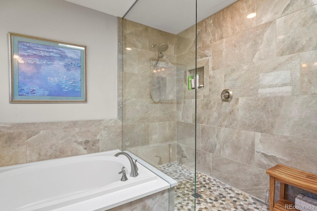 2146 S Ellis Ct, Lakewood, CO 80228 - full bathroom featuring a garden tub and a tile shower