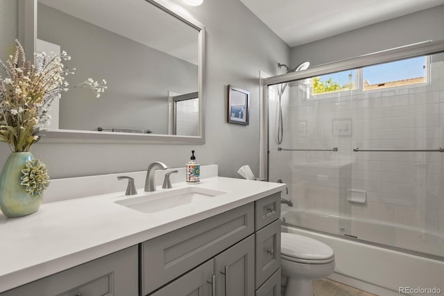 2146 S Ellis Ct, Lakewood, CO 80228 - full bathroom featuring vanity, toilet, and combined bath / shower with glass door