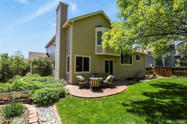 2146 S Ellis Ct, Lakewood, CO 80228 - rear view of property featuring a chimney and a patio