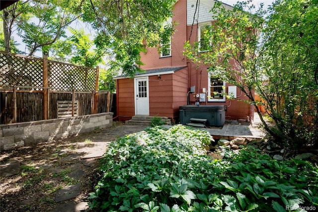 131 Fox St, Denver, CO 80223 - fenced backyard featuring a hot tub and entry steps