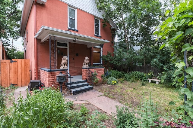 131 Fox St, Denver, CO 80223 - view of front of house with a porch and brick siding