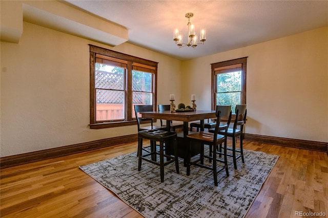 131 Fox St, Denver, CO 80223 - dining area featuring a chandelier and wood finished floors
