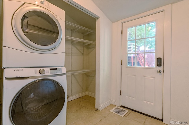 131 Fox St, Denver, CO 80223 - laundry room featuring stacked washer / drying machine and light tile patterned floors