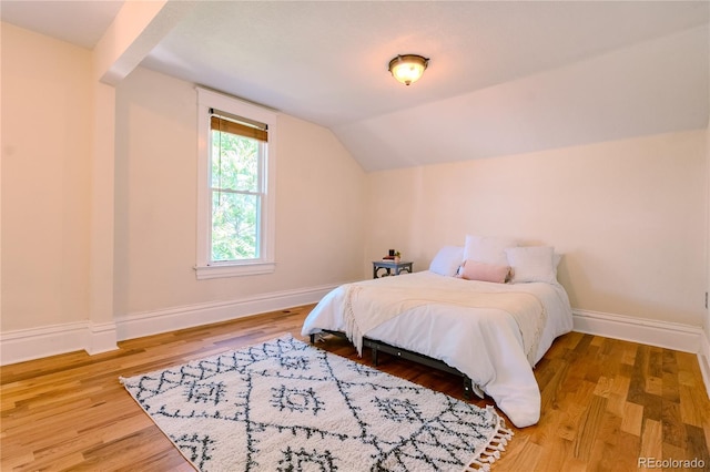 131 Fox St, Denver, CO 80223 - bedroom featuring lofted ceiling and wood finished floors