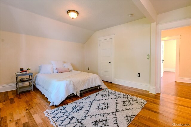 131 Fox St, Denver, CO 80223 - bedroom featuring wood finished floors and lofted ceiling