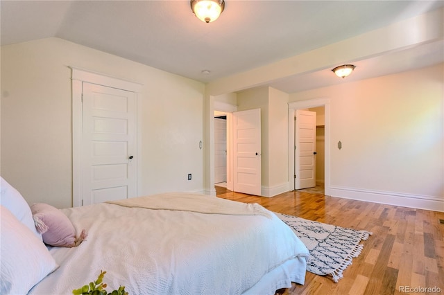 131 Fox St, Denver, CO 80223 - bedroom featuring wood finished floors and lofted ceiling