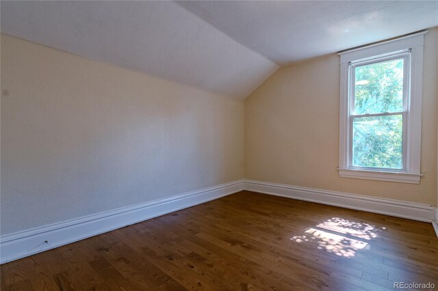 131 Fox St, Denver, CO 80223 - additional living space featuring vaulted ceiling and wood finished floors