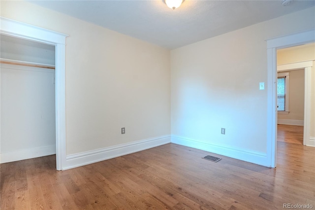 131 Fox St, Denver, CO 80223 - unfurnished bedroom with wood finished floors and a closet