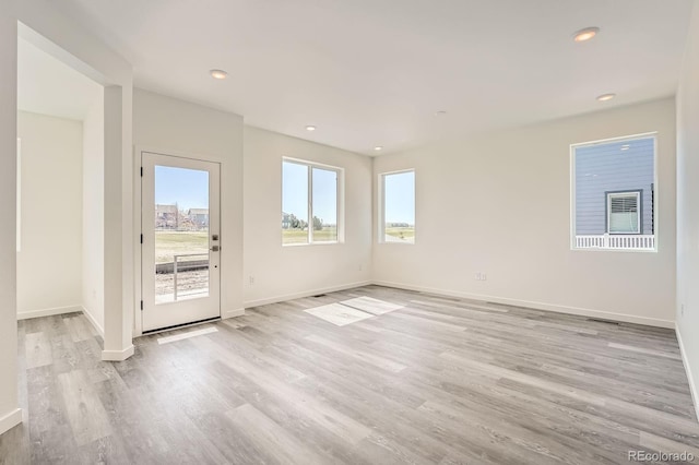 1290 S Algonquian St, Aurora, CO 80018 - spare room with light wood-type flooring, baseboards, and recessed lighting