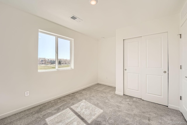 1290 S Algonquian St, Aurora, CO 80018 - unfurnished bedroom with carpet, baseboards, and a closet