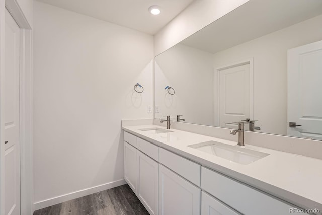 1290 S Algonquian St, Aurora, CO 80018 - full bath with double vanity, wood finished floors, and baseboards