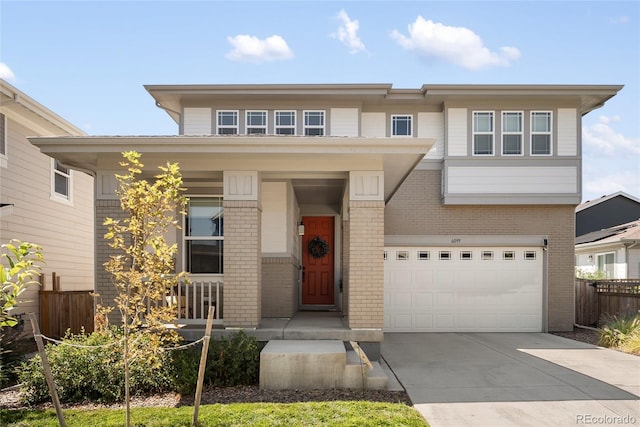 6099 N Netherland Ct, Aurora, CO 80019 - view of front facade with brick siding, a porch, concrete driveway, and a garage