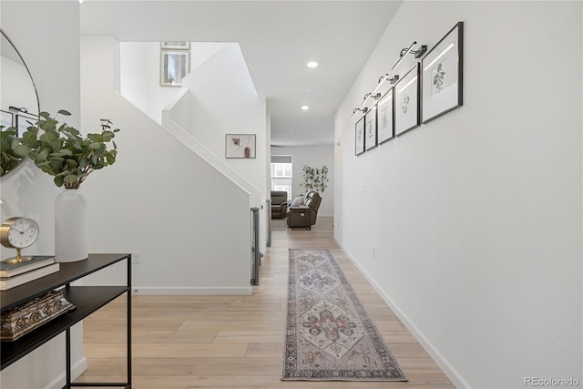 6099 N Netherland Ct, Aurora, CO 80019 - hallway featuring light wood-style flooring, recessed lighting, stairs, and baseboards