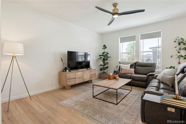 6099 N Netherland Ct, Aurora, CO 80019 - living area with light wood-style flooring, ceiling fan, and baseboards