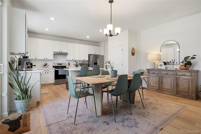 6099 N Netherland Ct, Aurora, CO 80019 - dining space with a chandelier, light wood finished floors, and recessed lighting