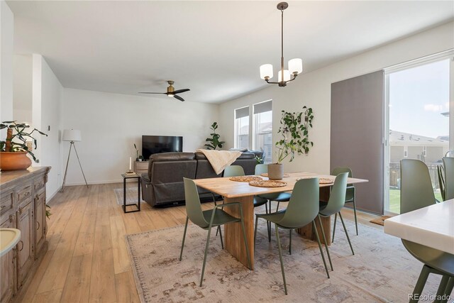 6099 N Netherland Ct, Aurora, CO 80019 - dining room featuring light wood finished floors, ceiling fan, and a chandelier