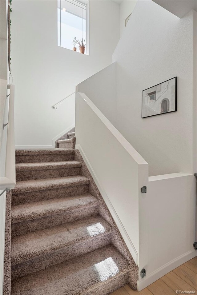 6099 N Netherland Ct, Aurora, CO 80019 - stairway with wood finished floors and baseboards
