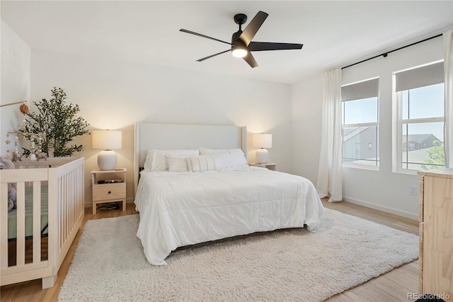 6099 N Netherland Ct, Aurora, CO 80019 - bedroom with light wood finished floors, baseboards, and a ceiling fan