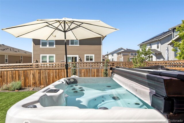 6099 N Netherland Ct, Aurora, CO 80019 - rear view of house with a hot tub and a residential view