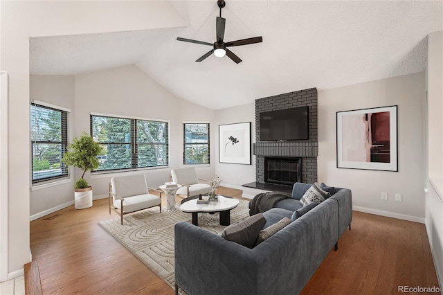 18 Brixham Ct, Castle Pines, CO 80108 - living room featuring ceiling fan, baseboards, a brick fireplace, wood finished floors, and high vaulted ceiling