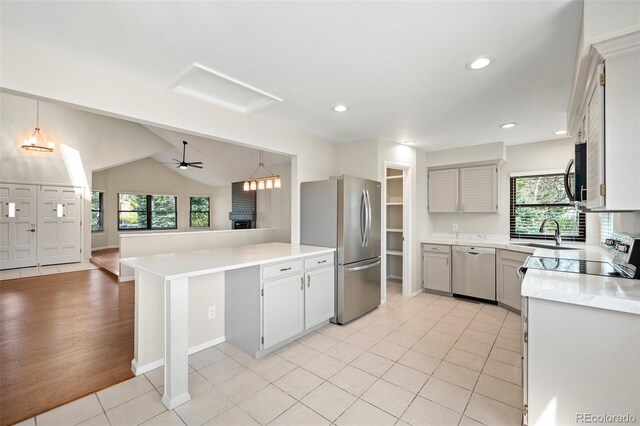 18 Brixham Ct, Castle Pines, CO 80108 - kitchen featuring appliances with stainless steel finishes, a sink, plenty of natural light, a peninsula, and recessed lighting
