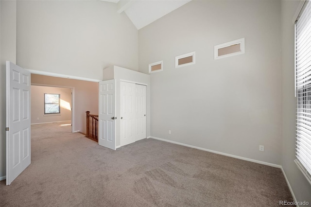 18 Brixham Ct, Castle Pines, CO 80108 - unfurnished bedroom with high vaulted ceiling, carpet, baseboards, beam ceiling, and a closet