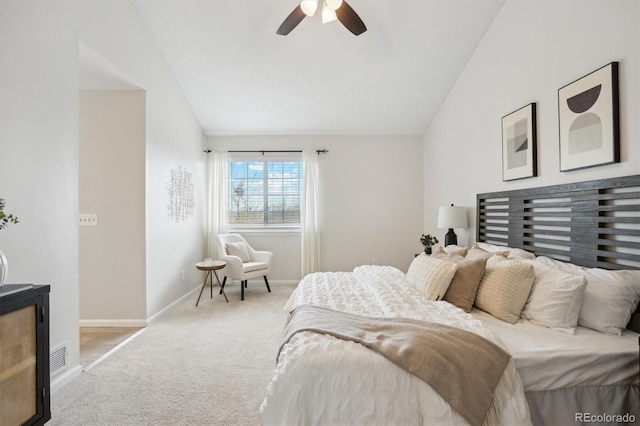 bedroom featuring a ceiling fan, baseboards, carpet, and vaulted ceiling