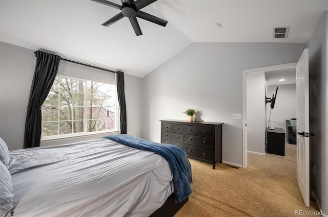 bedroom featuring vaulted ceiling, light colored carpet, and ceiling fan