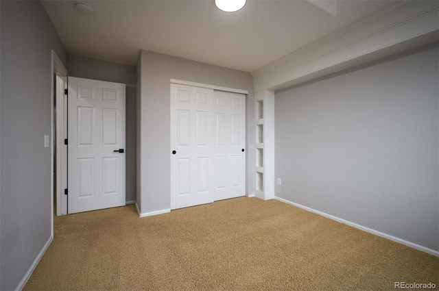 unfurnished bedroom featuring carpet floors and a closet