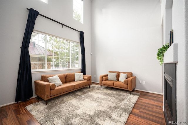 12826 W Brittany Dr, Littleton, CO 80127 - living area with healthy amount of natural light, dark wood finished floors, and a high ceiling