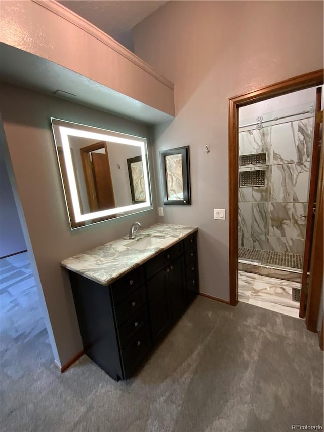 bathroom with a shower and vanity