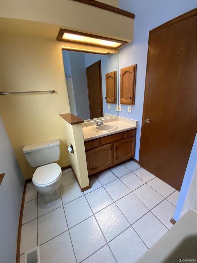 bathroom featuring vanity, tile patterned flooring, and toilet