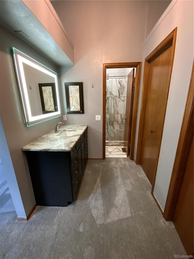 bathroom with walk in shower and vanity