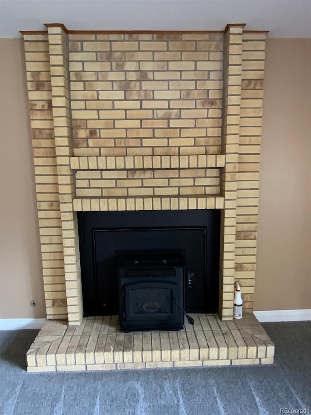 interior details with carpet floors and a fireplace