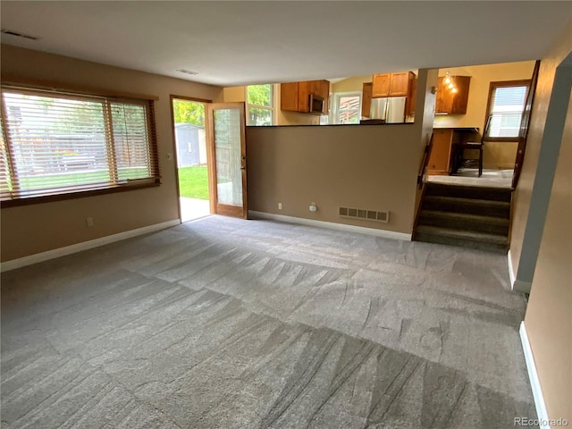 unfurnished living room with light carpet