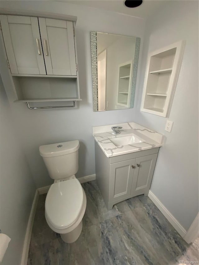 bathroom featuring wood-type flooring, vanity, and toilet