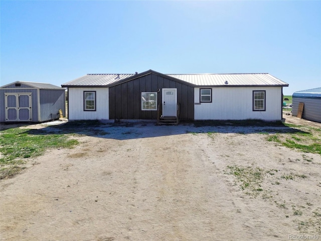 5525 S Johnson Rd, Rush, CO 80833 - view of front of property with entry steps, a storage shed, metal roof, and an outdoor structure