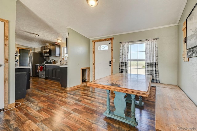 5525 S Johnson Rd, Rush, CO 80833 - foyer featuring dark wood finished floors, ornamental molding, and a textured ceiling